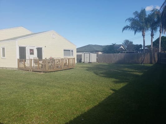 Open backyard area with deck and seating.