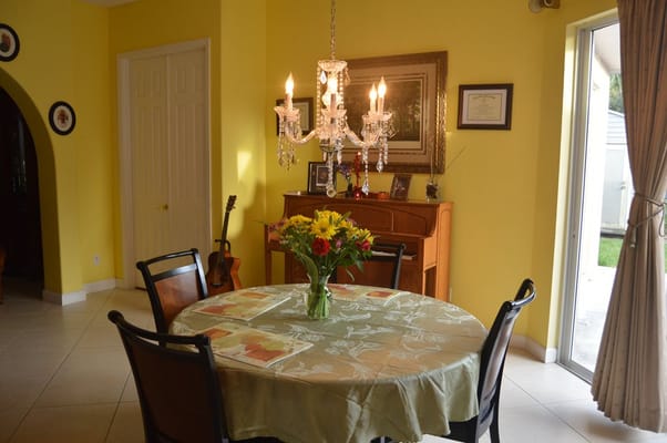 Charming dining area with a chandelier and flowers