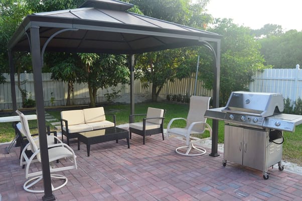Outdoor seating area with gazebo and grill