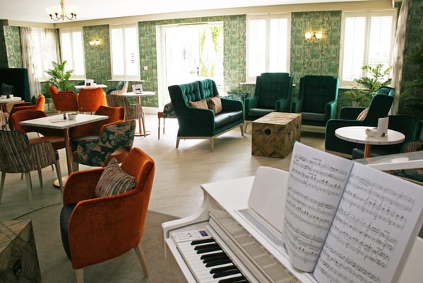 Cozy common area with sofas and a piano