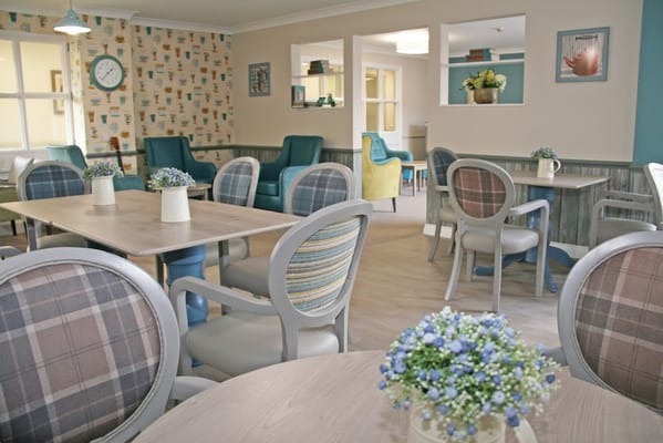 Bright common area with seating and floral decor