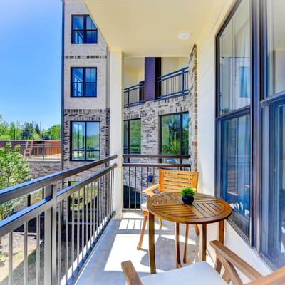 Balcony view of a residential building with outdoor seating