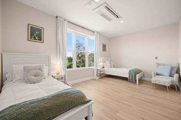 Cozy resident room with two beds and natural light