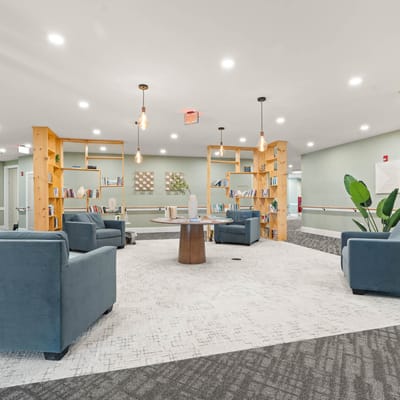 Comfortable common area with seating and bookshelves