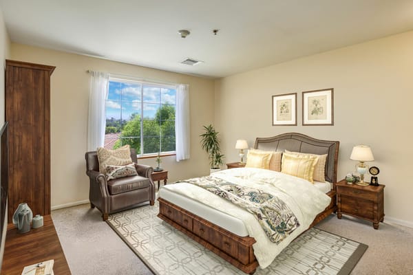 Private resident room with bed and armchair