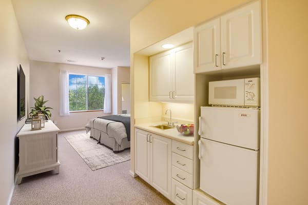Interior view of a private resident room with kitchenette