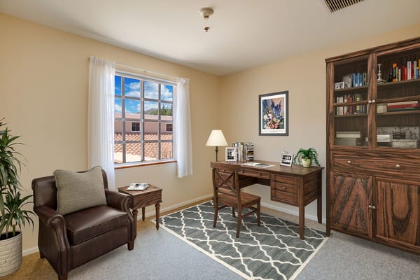 Cozy resident room with a desk and window view