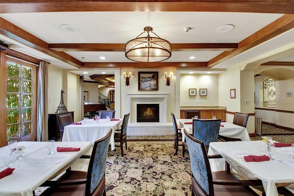 Elegant dining room with fireplace and decorative tables