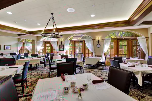 Elegant dining room with large windows and table settings