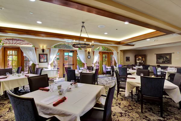 Dining room with elegantly set tables and natural light