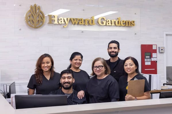 Staff members smiling at the reception area