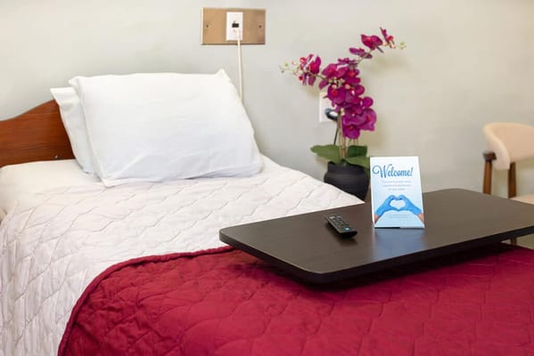 Cozy resident room with welcome note and flowers