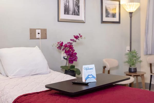 Cozy room setup with welcome sign and flowers
