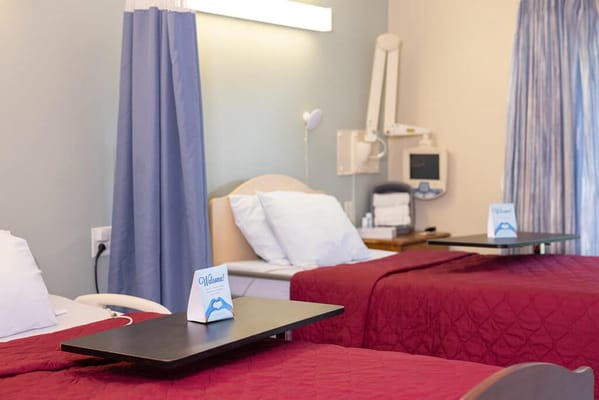 Interior view of a resident room with beds and amenities