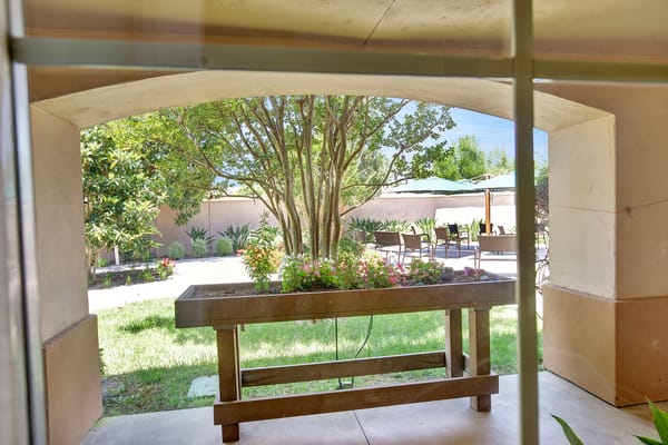 View of a garden area with flowers and seating.