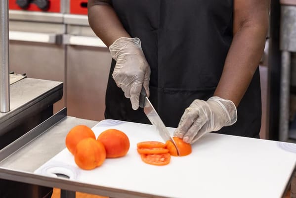 Staff member preparing fresh vegetables in the kitchen