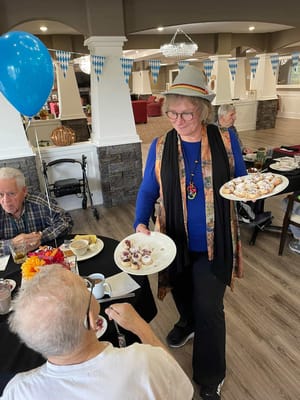 Staff serving food to residents during an event