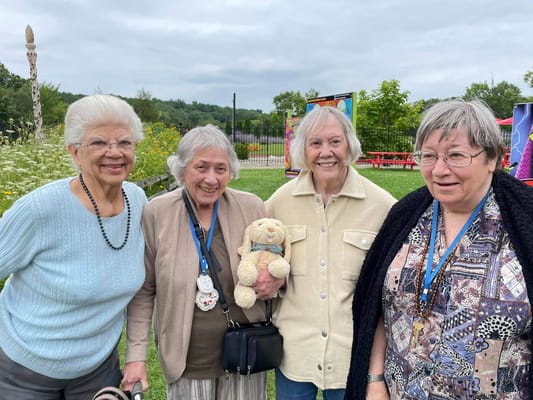 Four residents enjoying time outdoors in a garden