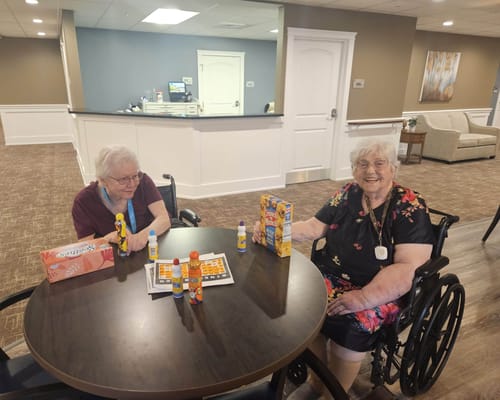 Residents enjoying a game at a common area table