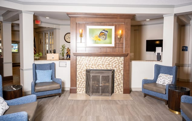 Comfortable lounge area with blue armchairs and a fireplace