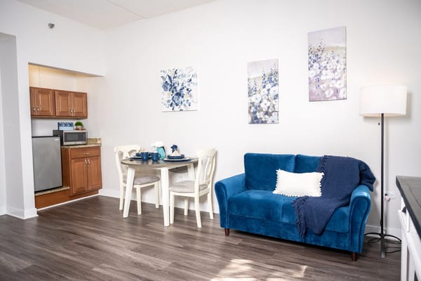 Cozy living space with a blue couch and dining area