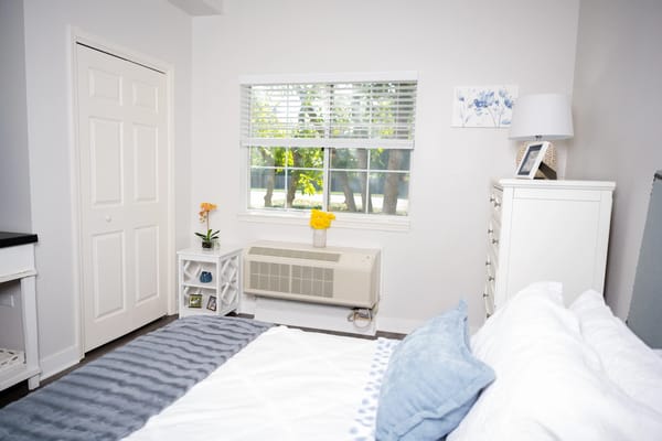 A cozy resident room with a bed and window