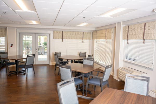 A bright and spacious common area with tables and chairs