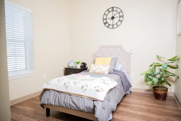 Cozy private room with a bed and a clock