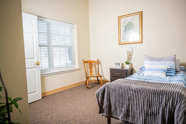 Cozy private room with bed and chair