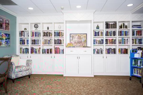 A cozy library area with bookshelves and seating