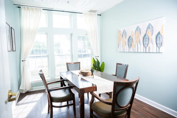 Bright dining area with a wooden table and chairs