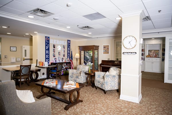 Common area with chairs and piano in a senior living facility