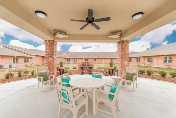 Outdoor patio area with seating and landscaping
