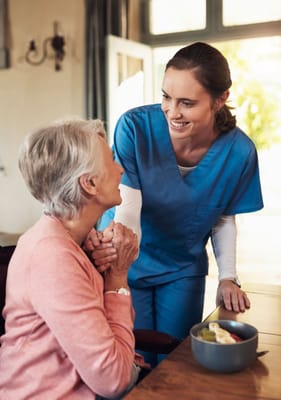 Caregiver interacting with resident over a meal