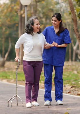 Caregiver assisting a resident in an outdoor setting