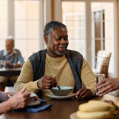 Residents enjoying a meal in a dining area