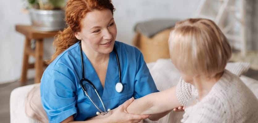 Nurse assisting a resident in a cozy room setting