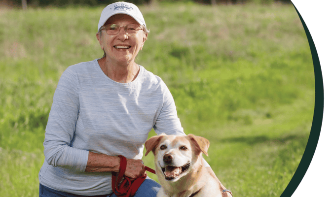 Senior resident enjoying time outdoors with a dog