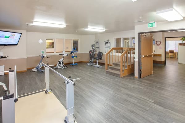 Interior view of a therapy room with exercise equipment