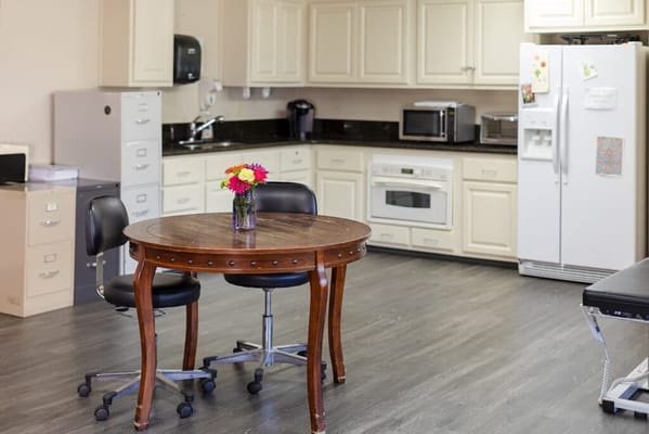 A kitchen space with a table and flowers