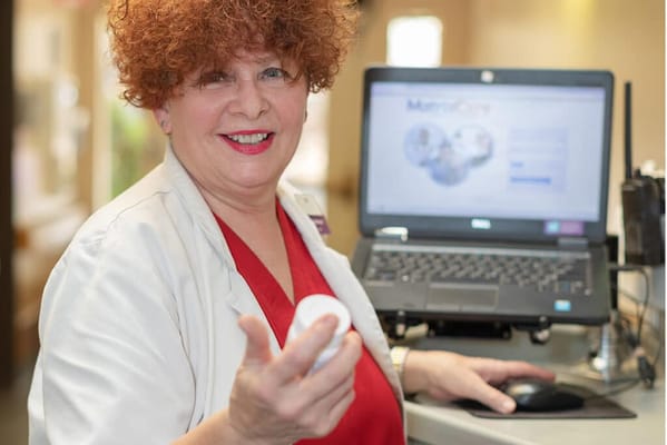 A staff member at a nursing facility engaging with technology