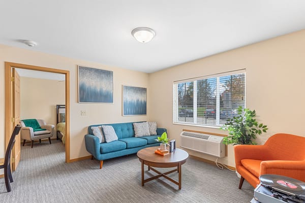 A cozy resident room with colorful furniture and natural light