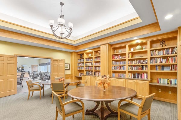 Bright common area with bookshelves and table