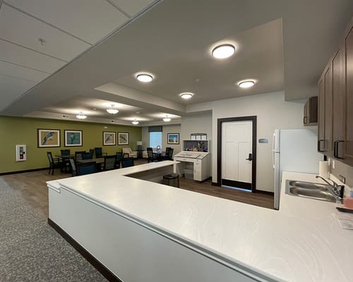 Bright common area with seating and art on the walls