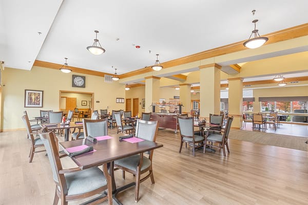 Dining area with tables and chairs set for meals