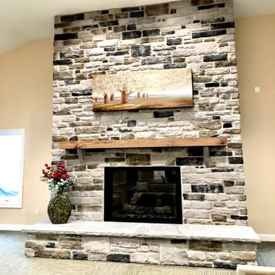 Interior view of a lounge area with a stone fireplace
