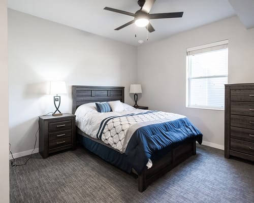 A cozy private resident room with a bed and furniture