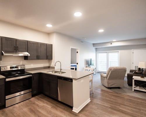 Bright kitchen and living area in a resident suite