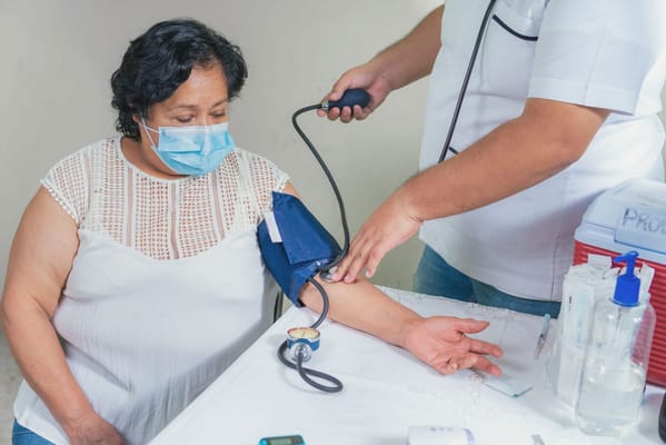 Patient having blood pressure checked by a nurse