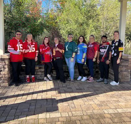Staff members wearing jerseys in an outdoor space
